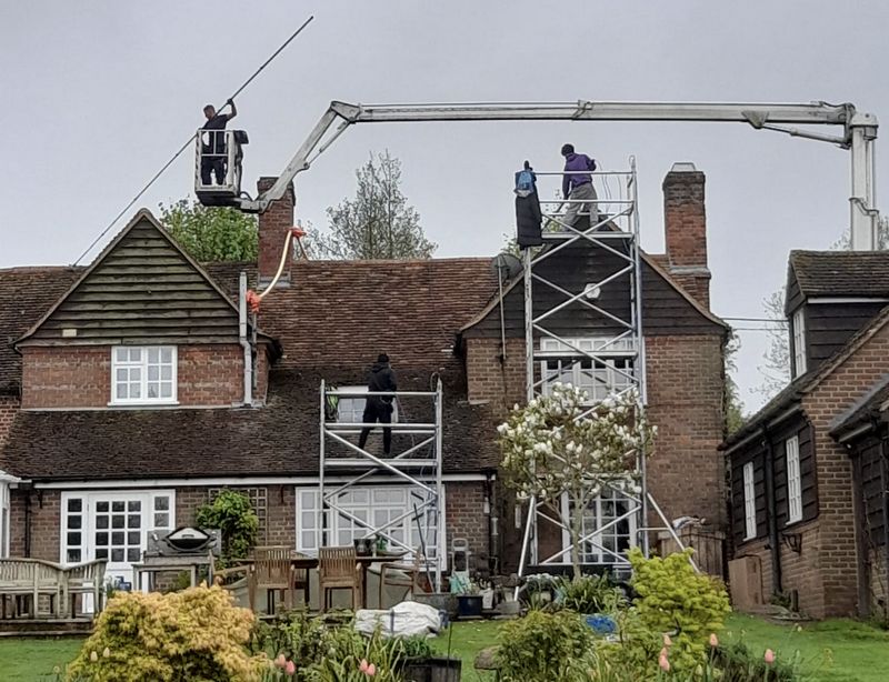The Roof Moss Cleaners using cherry picker and scaffolding to clean roof safely and professionally in Esher, Surrey