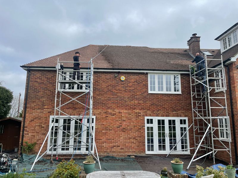 Roof cleaning carried out safely from scaffold towers by The Roof Moss Cleaners in Esher